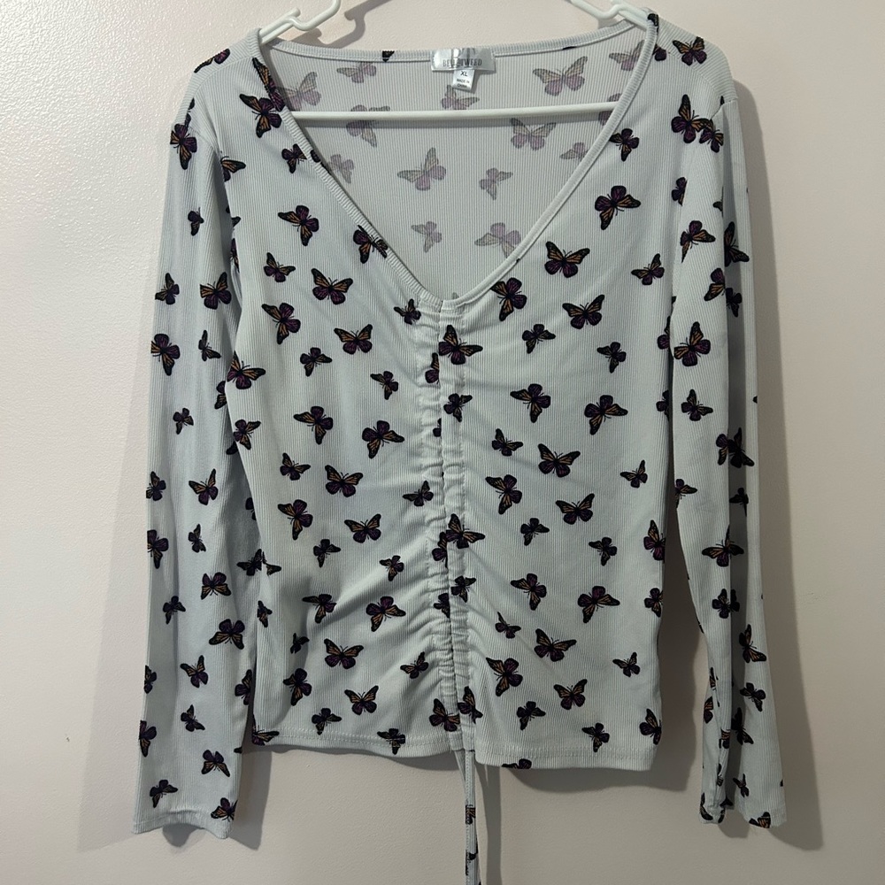 White butterfly shirt with draw string on front.